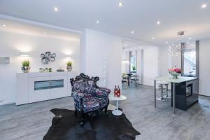 a living room with a chair and a table at Design-Studiowohnung Haegestrasse in Gütersloh +13 photos