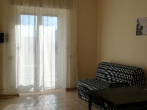 a living room with a couch and a window at Casa Vacanza Pappacoda in Agerola