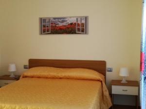 a bedroom with a bed and a picture on the wall at Casa Vacanza Pappacoda in Agerola