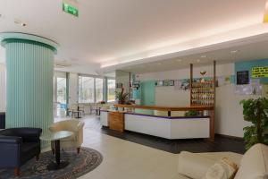 a lobby of a hospital with a table and chairs at Hotel Ideal Bianchini in Riccione