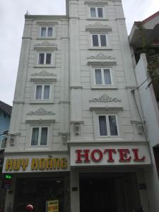 a white building with a hotel sign in front of it at Huy Hoang 1 Hotel in Ho Chi Minh City