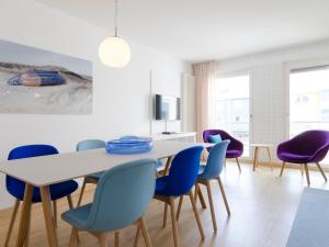 a dining room with a table and chairs at atoll apartments in Helgoland