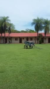 a bench in a field in front of a building at El Pantanal Hotel & Resort in San José de Chiquitos