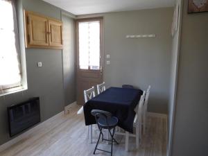 a dining room with a blue table and chairs at GITE "LE VALLON DE PARAY" in Paray-le-Monial