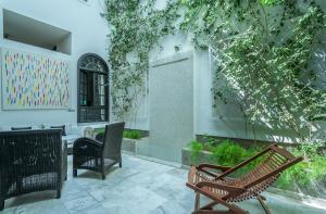 a patio with two benches and a table and chairs at Riad Sapphire & Spa in Marrakesh