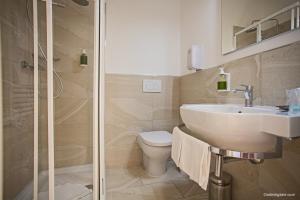 a bathroom with a toilet and a sink and a shower at Hotel La Pace in Pisa