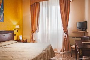 Postel nebo postele na pokoji v ubytování Hotel La Pace