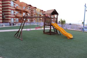 a playground with a slide and a swing at Ain El Sokhna Chalet in Ain Sokhna