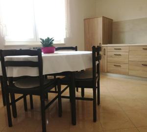 a dining room table and chairs in a room at Accommodation Vitalio in Umag