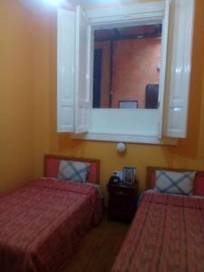 Postel nebo postele na pokoji v ubytování Hotel Isabel
