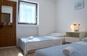 Postel nebo postele na pokoji v ubytování Apartments Jadranovo