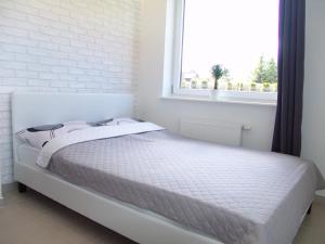 Postel nebo postele na pokoji v ubytování Apartament Białe Piaski