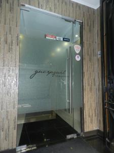 a glass elevator in a building with signs on it at Hotel Guayaquil in Santiago