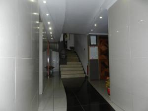 a hallway with stairs in a building with lights at Hotel Guayaquil in Santiago