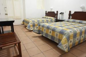 Tempat tidur dalam kamar di Hotel de los baños
