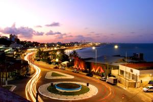 a city street at night with traffic on the road at Natal Praia Hotel in Natal