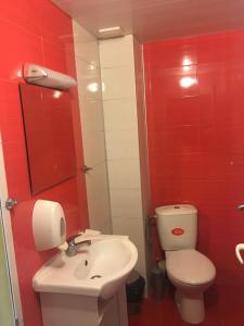 a bathroom with a white toilet and a sink at Guest House Pri Germanetsa in Pavel Banya +20 photos
