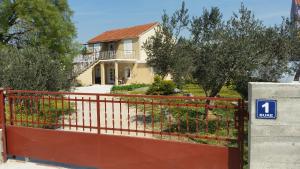 a house with a red gate in front of it at Apartment Nika in Šibenik