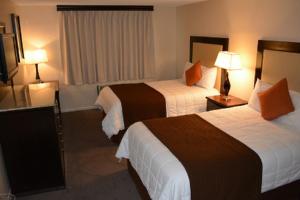 a hotel room with two beds and two lamps at Longhorn Boulder Highway in Las Vegas