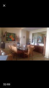 a dining room with a table and chairs at Oceanfront Apartment at Punta Diamante in Acapulco