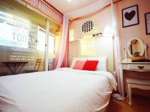 1 dormitorio con cama blanca y almohadas rojas en Han River Residence & Guesthouse, en Seúl