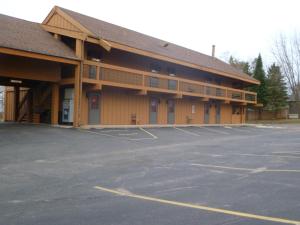 a parking lot in front of a building at Timber Inn Motel in Phillips