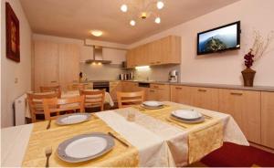 a kitchen and dining room with a table with plates on it at Haus Alpenglühn in Längenfeld