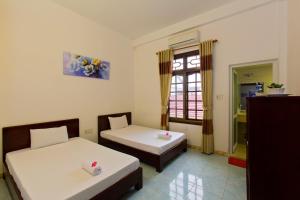 Postel nebo postele na pokoji v ubytování Mango Garden Hoi An Homestay