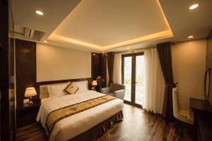a hotel room with a bed and a large window at Sapa Wings Hotel in Sapa