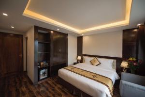Postel nebo postele na pokoji v ubytování Sapa Wings Hotel