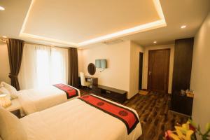 Postel nebo postele na pokoji v ubytování Sapa Wings Hotel