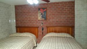 Postel nebo postele na pokoji v ubytování Hotel Rex