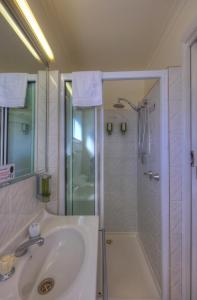 
a bathroom with a shower, sink, and toilet at Dannebrog Lodge in Devonport
