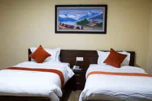 Rúm í herbergi á Sampada Garden Resort