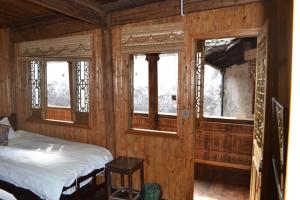 Ένα ή περισσότερα κρεβάτια σε δωμάτιο στο Huangshan Xidi Shang De Tang
