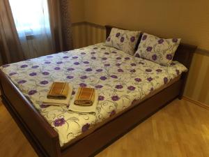 a bed with two books on top of it at Apartment on Kostyushka 20 in Lviv
