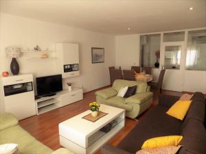 a living room with a couch and a tv at Apartment Anamarija in Njivice