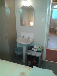 a bathroom with a sink and a mirror at Overnight Stays Stockport in Stockport