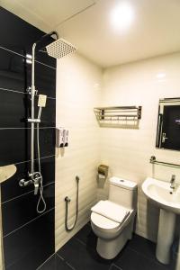 a bathroom with a toilet and a sink at Hotel Lavender Senawang in Seremban