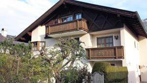 a house with wooden balconies on top of it at Apartment Jasmin in Garmisch-Partenkirchen