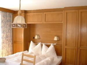 a bedroom with a bed with white pillows at Ferienwohnung Familie Höfler in Längenfeld