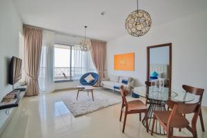 a living room with a table and chairs and a couch at New Arabian 29 Boulevard Downtown Dubai in Dubai