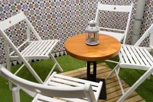 a table and chairs with a lantern on a patio at Imperial Mérida in Merida