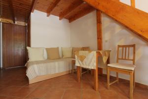a room with a couch and a table and a chair at George SkyrosStudios in Skiros