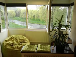a bedroom with a bed and a large window at Green Apartment in Odorheiu Secuiesc