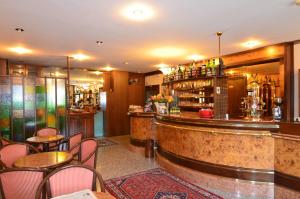 a bar in a restaurant with tables and chairs at Hotel Magnolia in Preganziol