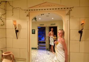 a man and a woman standing in a doorway at Hotel am Römerweg in Fiss