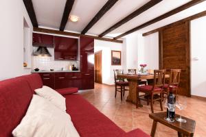 a living room with a red couch and a table at Villa MOYA 1 in Fužine