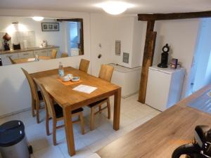 a kitchen and dining room with a wooden table and chairs at Ferienwohnung Jansen "Eins" in Bad Schwalbach