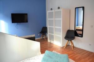 a living room with a blue wall and a mirror at Work & stay exclusive apartment in Düsseldorf